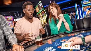 Live dealer at Dragon Tiger table with cards displayed